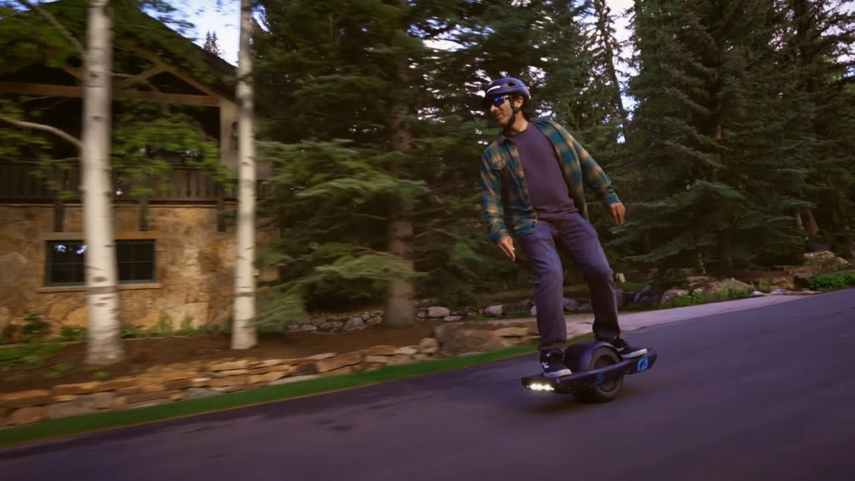 Men wearing AURA for onewheel riding