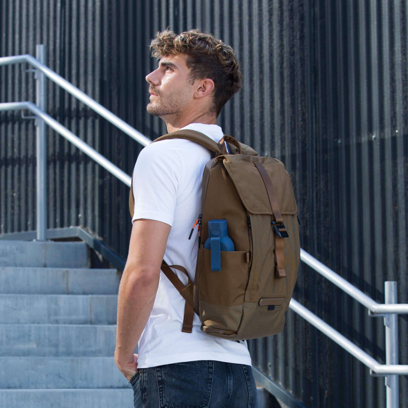 Homem comTORCH  UNIT 1 TORCH , na elegante Desert Tan , e a garrafa UNIT 1