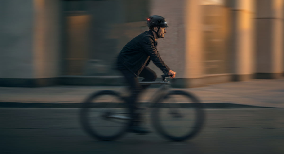 Person in Bewegung auf dem Rad mit AURA MIPS in der Dämmerung